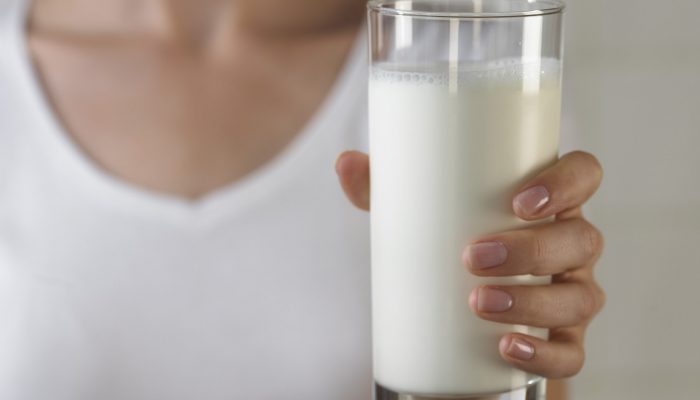 Holding glass of milk