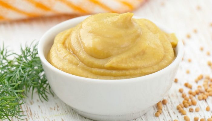 Mustard sauce in white bowl. Stock photo
