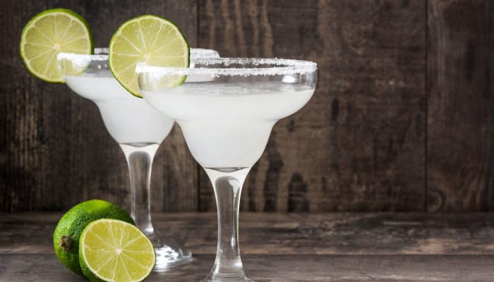 Margarita cocktail on white wooden table